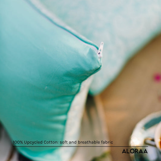 Close-up of ALORAA paisley cushion cover in soft turquoise fabric with zipper detail