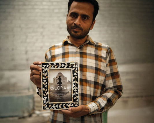 Mohammed, an ALORAA artisan in Sambhal, holding a handcrafted mother-of-pearl photo frame