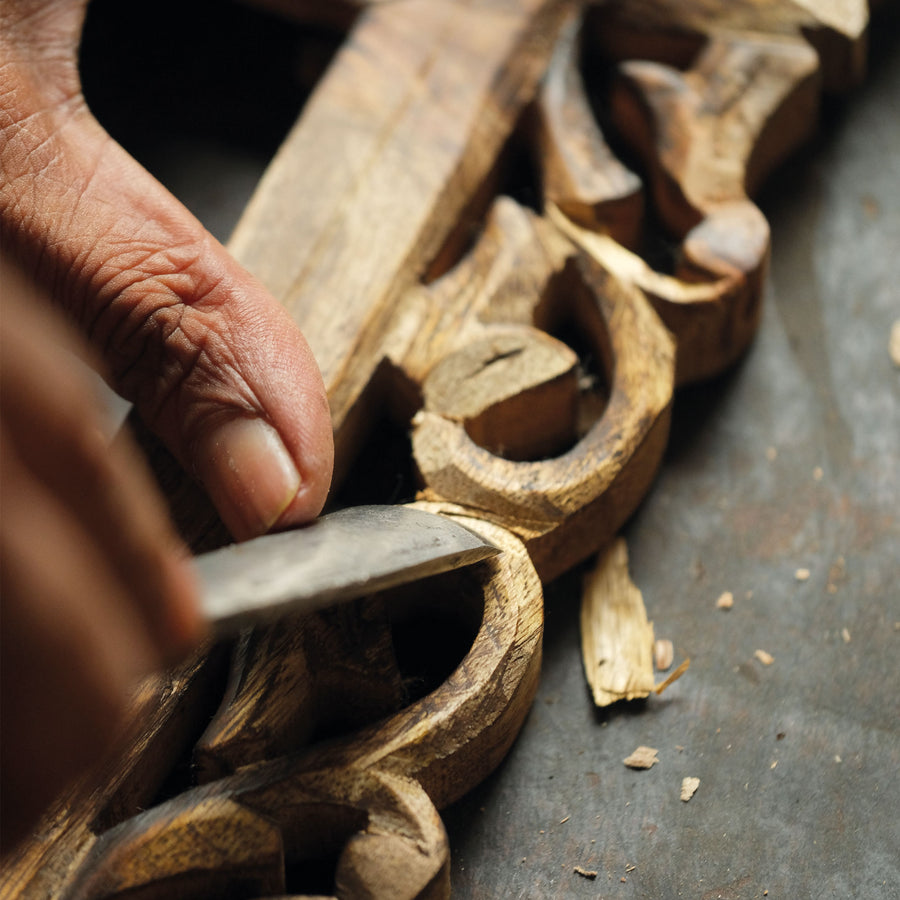 Hand-carved photo frame. Intricate designs drawn from temples and palaces, cut by hand from mango wood.