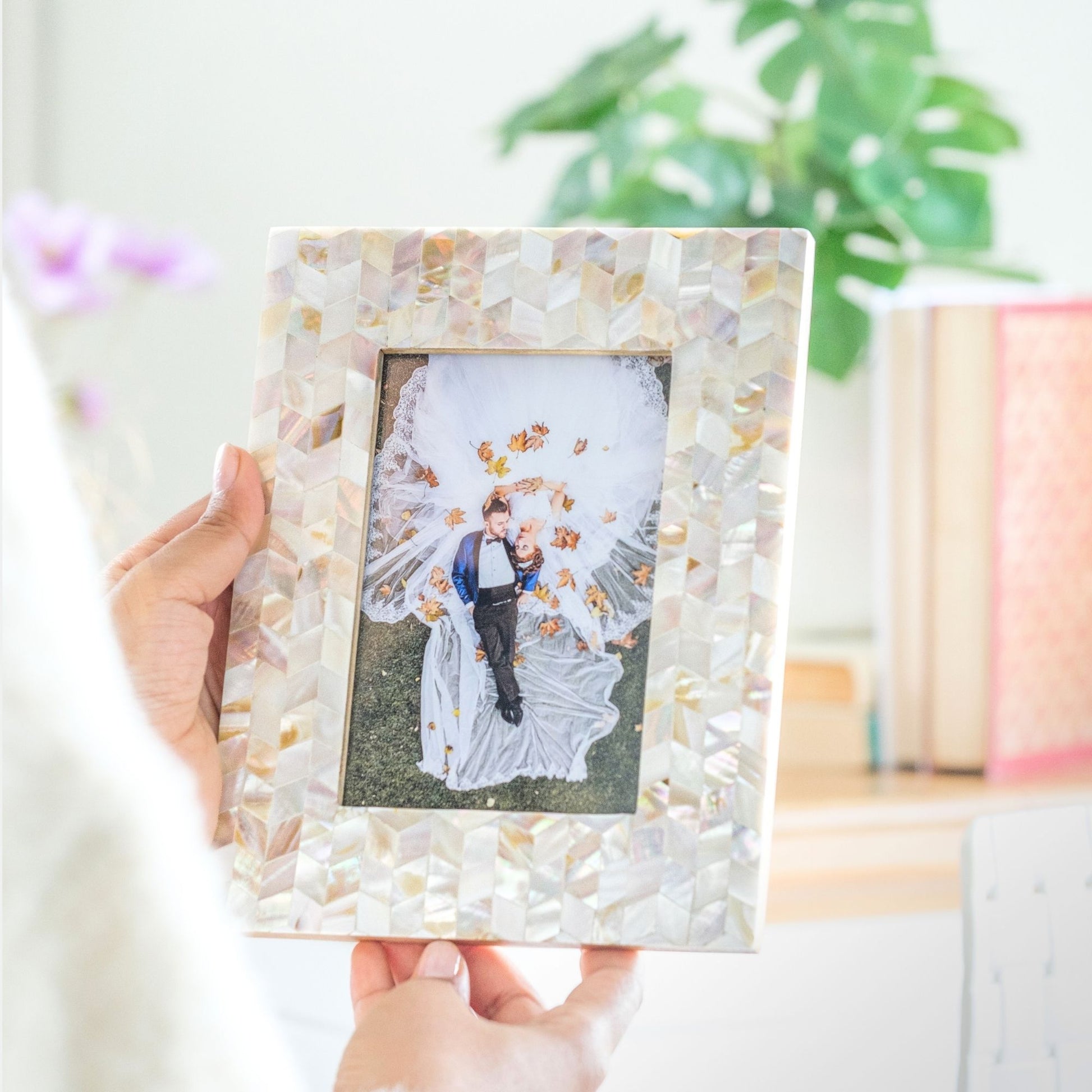 Handmade mother of pearl chevron photo frame held for scale
