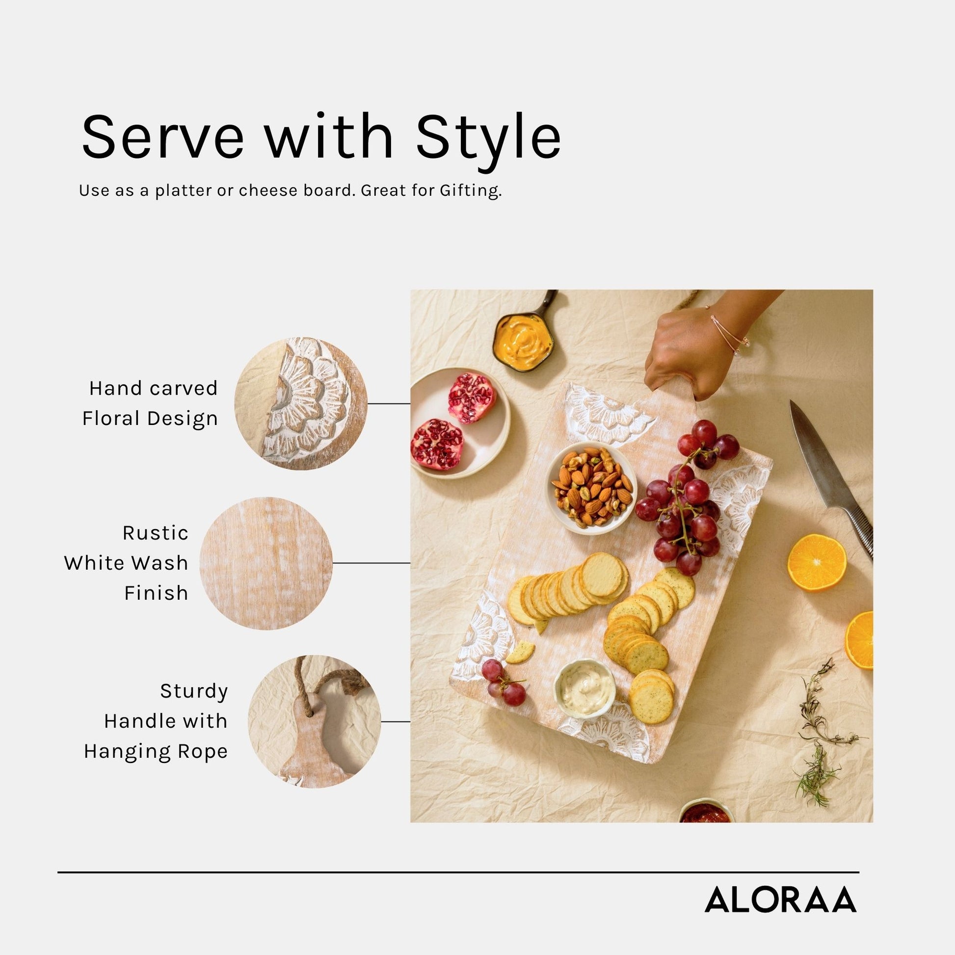 Hand carved wooden chopping board with floral design and rustic white wash finish used as a cheese platter with snacks
