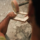 Artisan polishing a chevron mother of pearl photo frame during production - Indian handcraft | ALORAA