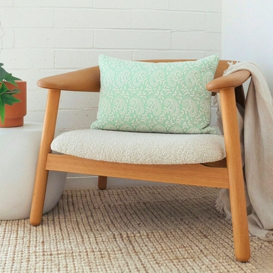 Minty green paisley print cushion cover on a wooden armchair - hand embroidered Indian cushion cover | ALORAA